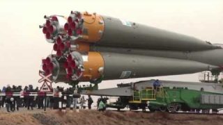 Expedition 27 Crew Prepares for Launch as their Soyuz Rocket Move to Launch Pad